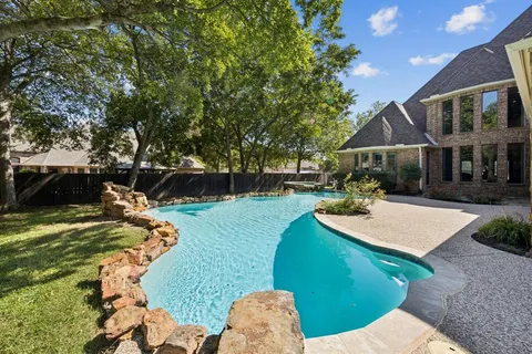 a view of a house with backyard and a tree