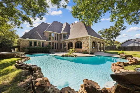 a view of a white house with a yard patio and fire pit