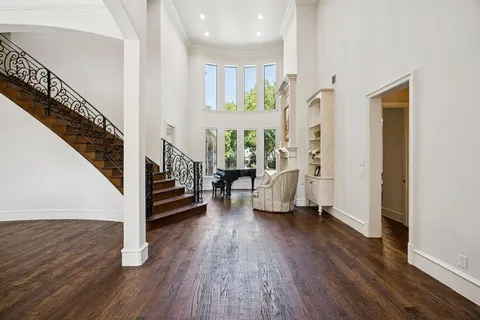 a view of an entryway with wooden floor and staircase