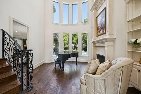 a living room with furniture fireplace and potted plants