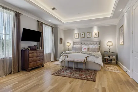 a bedroom with a bed and a flat screen tv