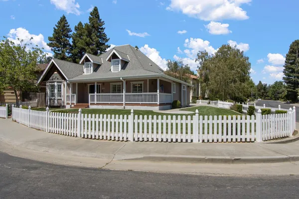 a front view of a house with a garden