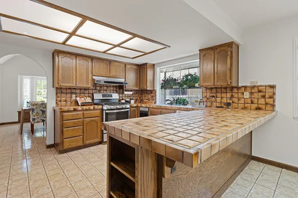 a kitchen with a stove a refrigerator and a sink