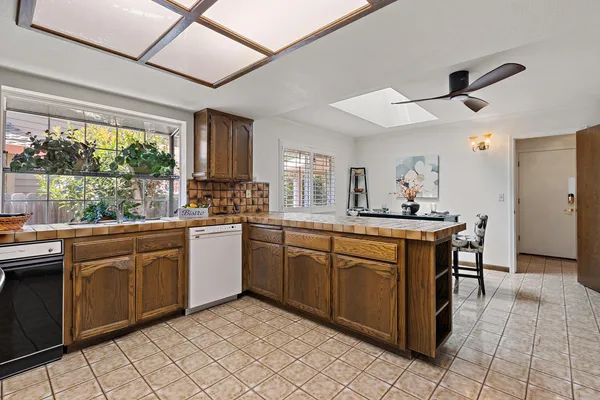 a kitchen with stainless steel appliances granite countertop a sink and cabinets