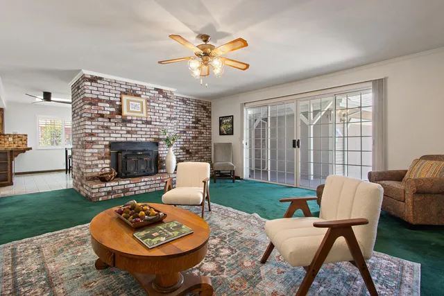 a living room with furniture a fireplace and a table