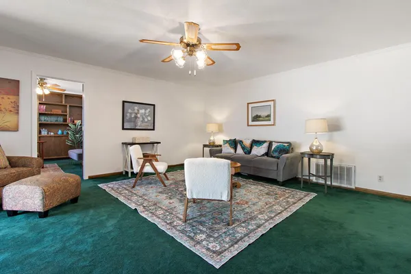 a living room with furniture and wooden floor