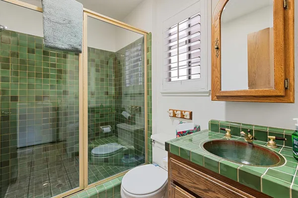a bathroom with a sink toilet and shower