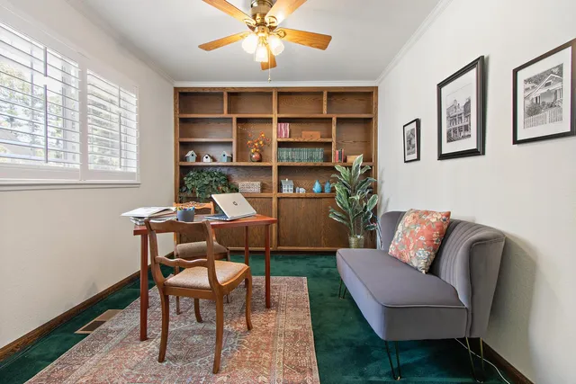 a work room with furniture and a book shelf