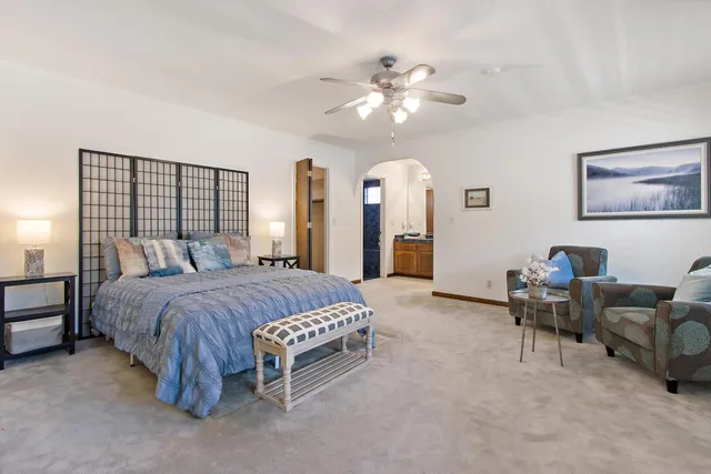 a spacious bedroom with a bed and furniture