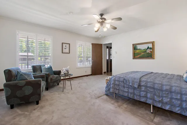 a bedroom with furniture and windows