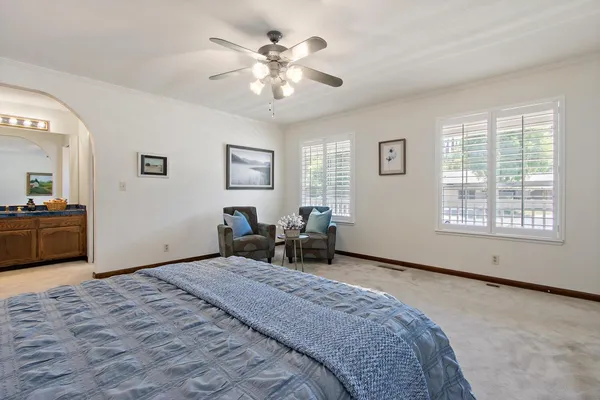 a bedroom with a bed and a chandelier