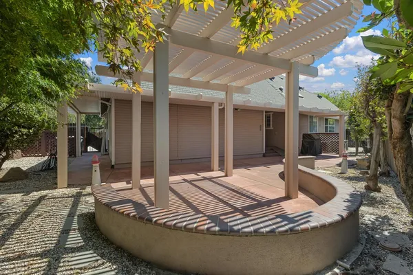 a view of a house with swimming pool and sitting area