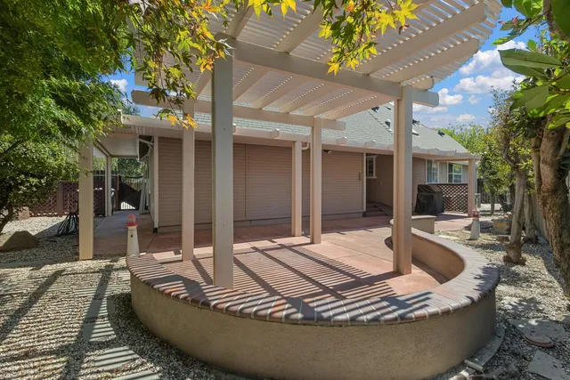 a view of a house with swimming pool and sitting area