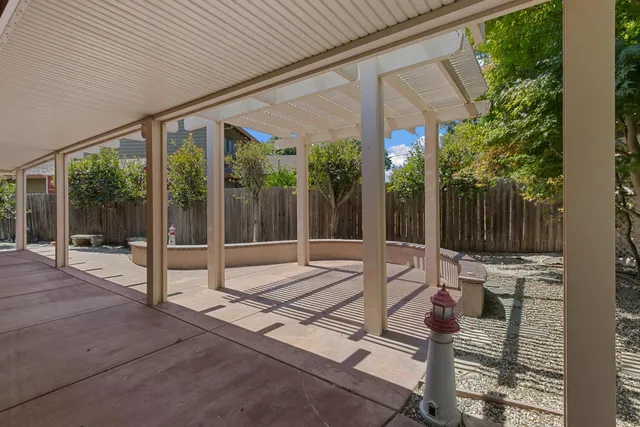 a building outdoor space with patio furniture and potted plants