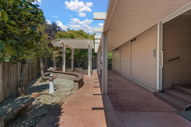 a view of a patio with a table and chairs