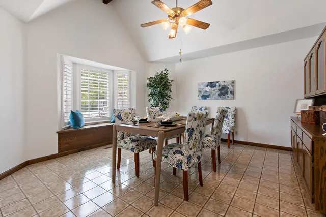 a view of a dining room with furniture and a chandelier