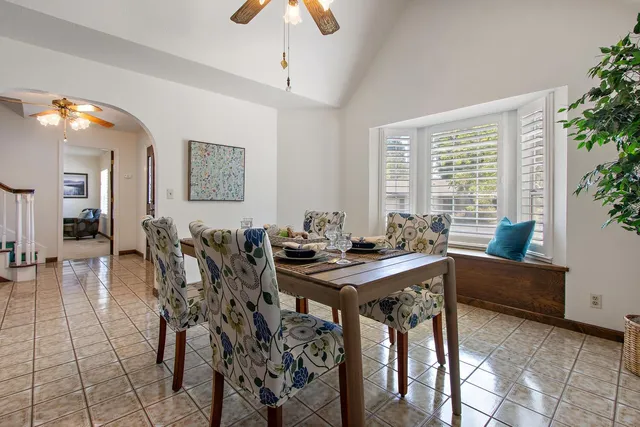 a view of a dining room with furniture and chandelier