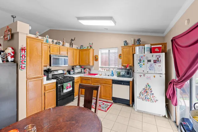 a kitchen with a refrigerator and a stove