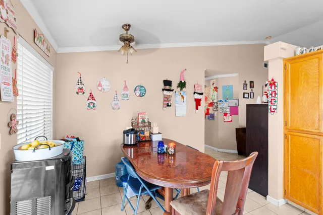 a dining room with furniture and a floor to ceiling window