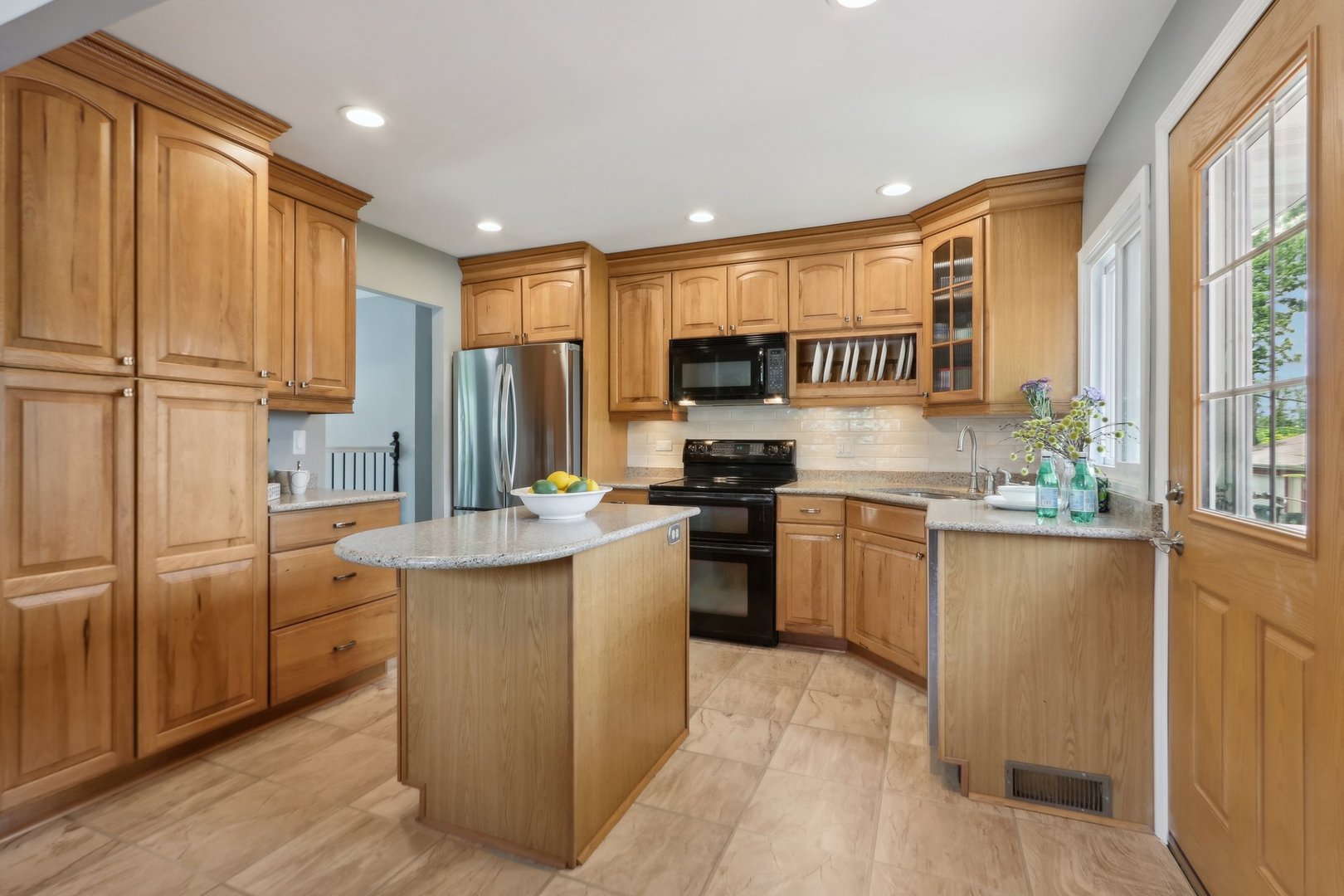 785 Cambridge Lane Hoffman Estates, IL 60169 - Photo 14 of 48 a kitchen with stainless steel appliances granite countertop a refrigerator a sink dishwasher a stove and a refrigerator with wooden floor