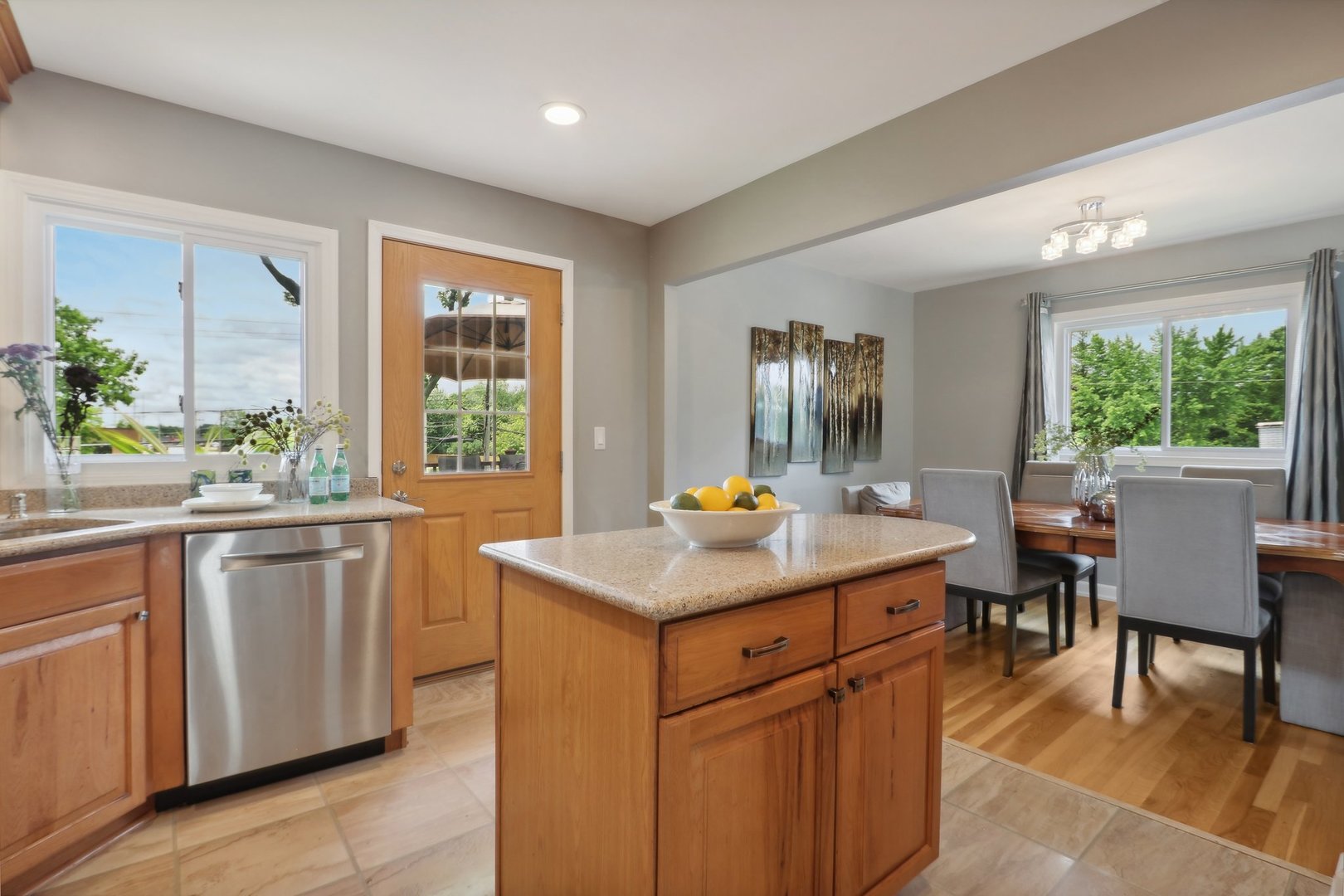 785 Cambridge Lane Hoffman Estates, IL 60169 - Photo 16 of 48 a kitchen with a stove a sink a dining table and chairs