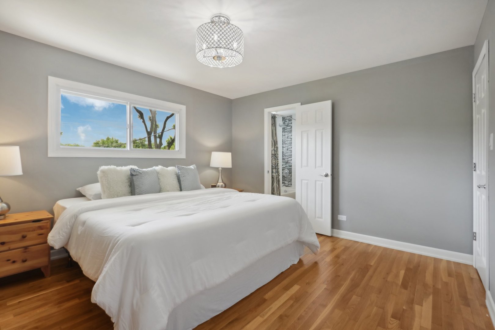 785 Cambridge Lane Hoffman Estates, IL 60169 - Photo 20 of 48 a bedroom with a large bed and a chandelier