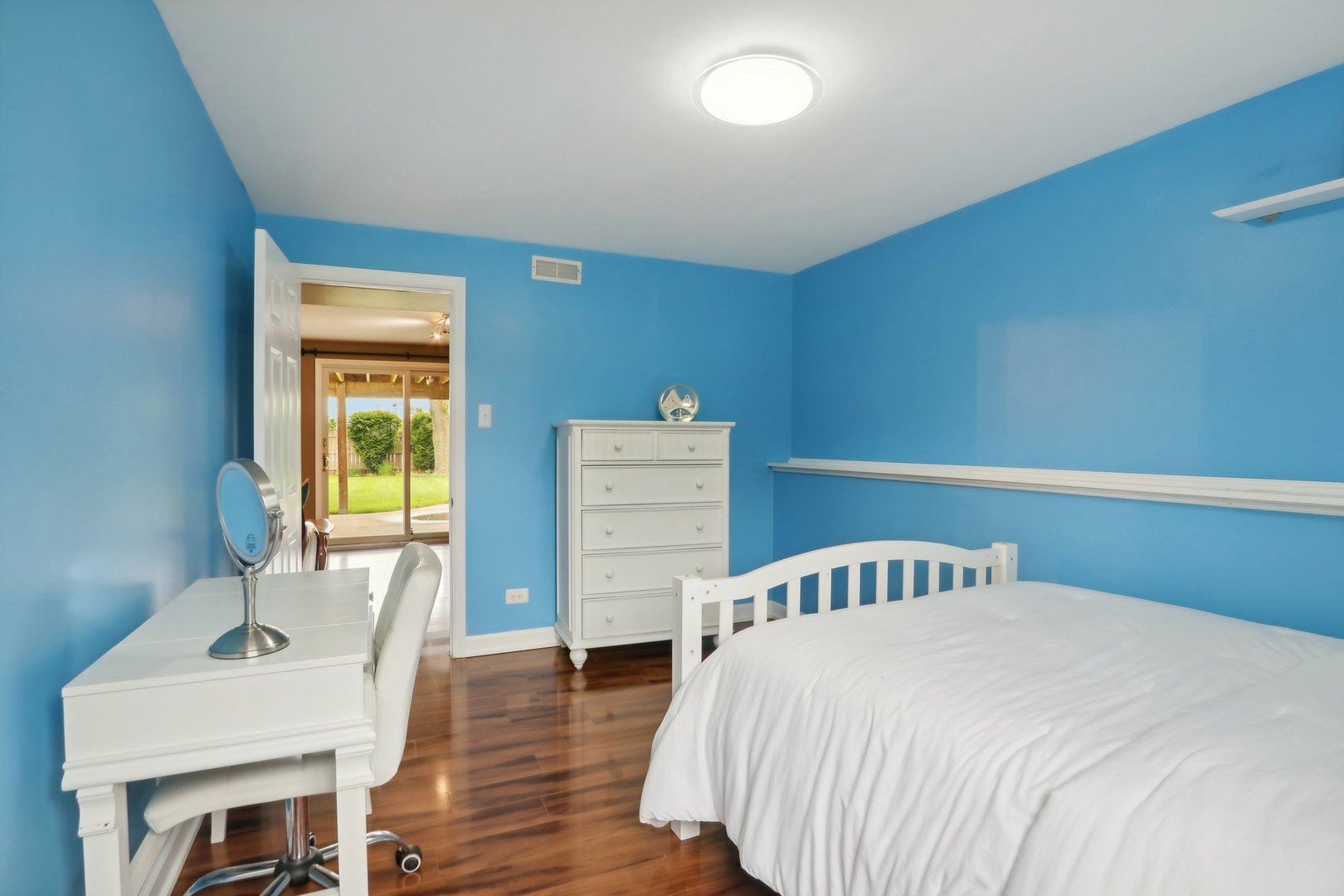 785 Cambridge Lane Hoffman Estates, IL 60169 - Photo 29 of 48 a bedroom with a bed and wooden floor