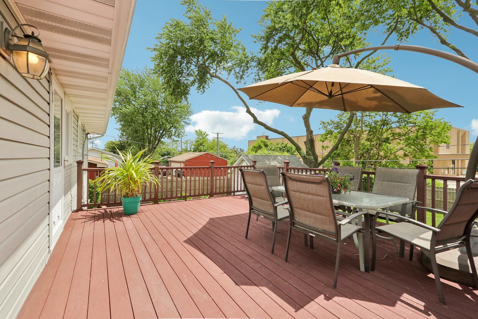 785 Cambridge Lane Hoffman Estates, IL 60169 - Photo 32 of 48 a view of a roof deck with table and chairs under an umbrella