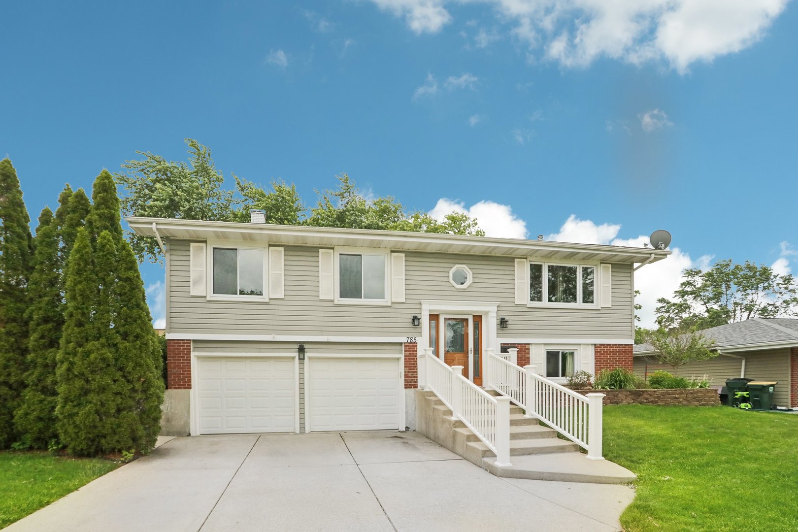 785 Cambridge Lane Hoffman Estates, IL 60169 - Photo 4 of 48 a white house that has tree in front of it