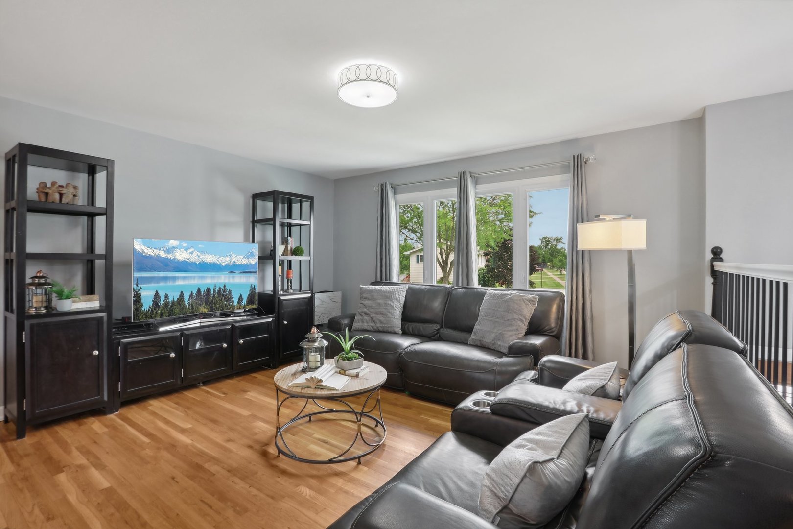 785 Cambridge Lane Hoffman Estates, IL 60169 - Photo 5 of 48 a living room with furniture and a flat screen tv