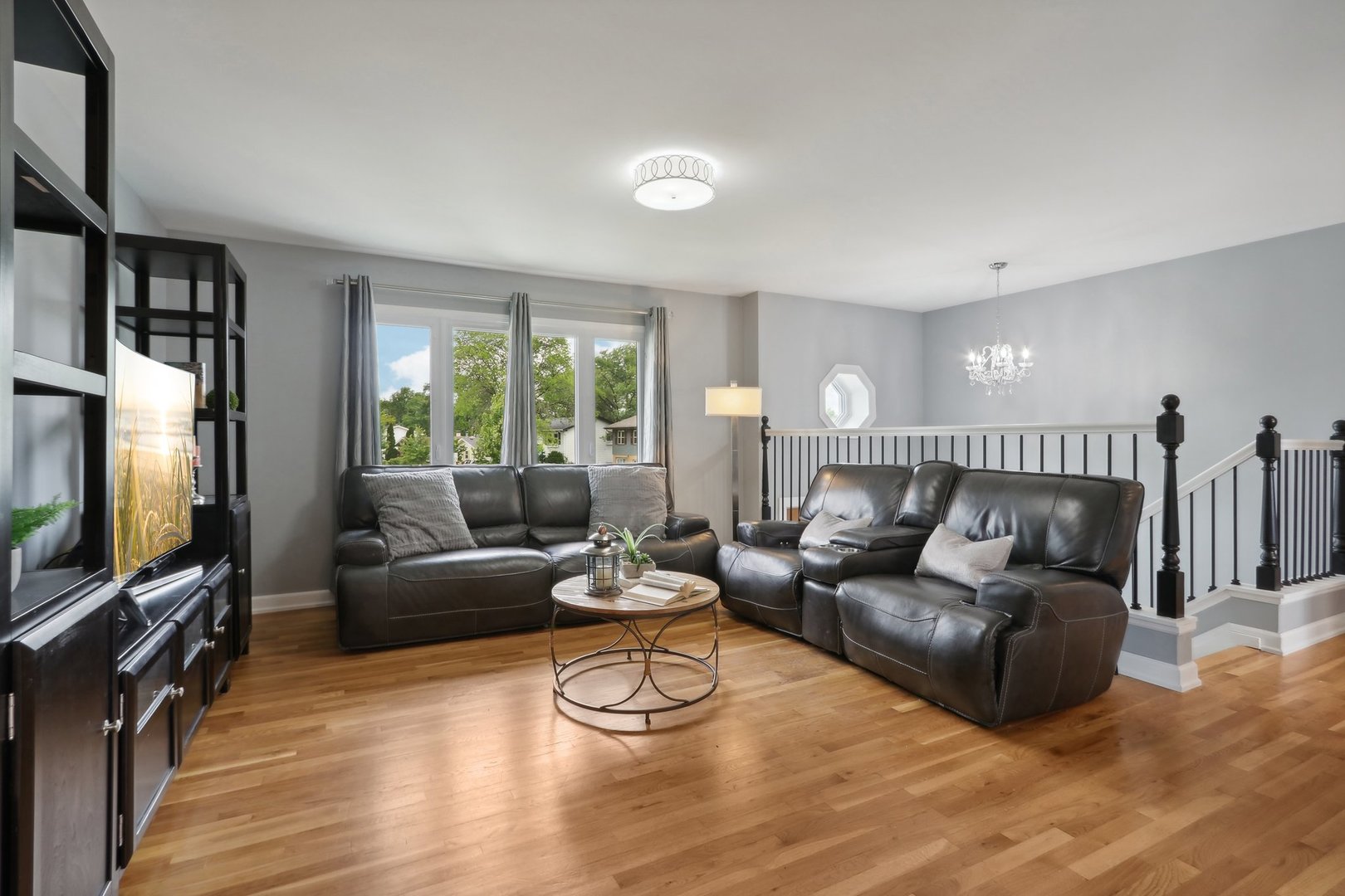 785 Cambridge Lane Hoffman Estates, IL 60169 - Photo 6 of 48 a living room with furniture and a flat screen tv