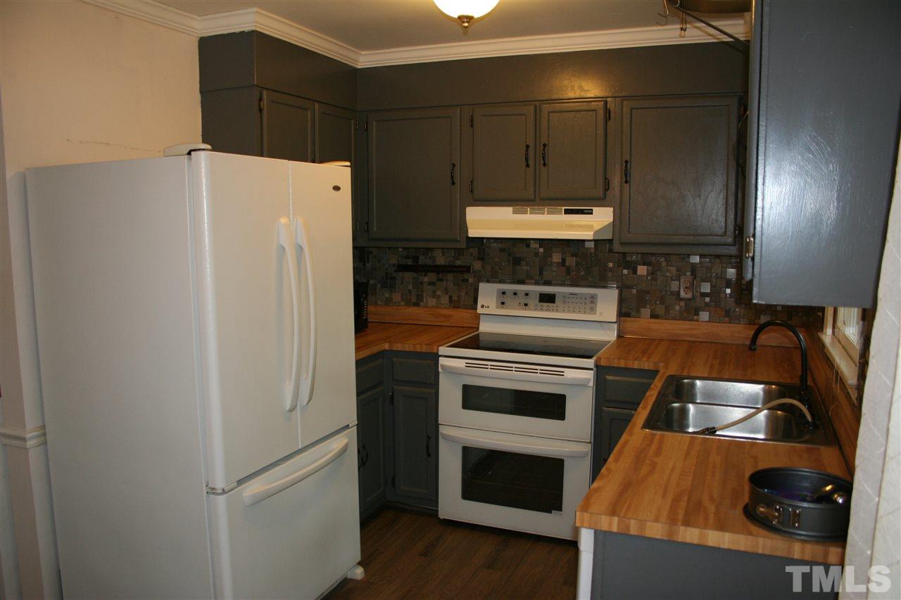 7705 Cart Track Trail Raleigh, NC 27615 - Photo 3 of 7 a kitchen with a refrigerator and a stove