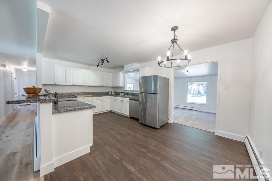 1325 Kings Court Reno, NV 89503 - Photo 3 of 14 a kitchen with stainless steel appliances granite countertop a refrigerator a sink dishwasher a stove and white cabinets with wooden floor