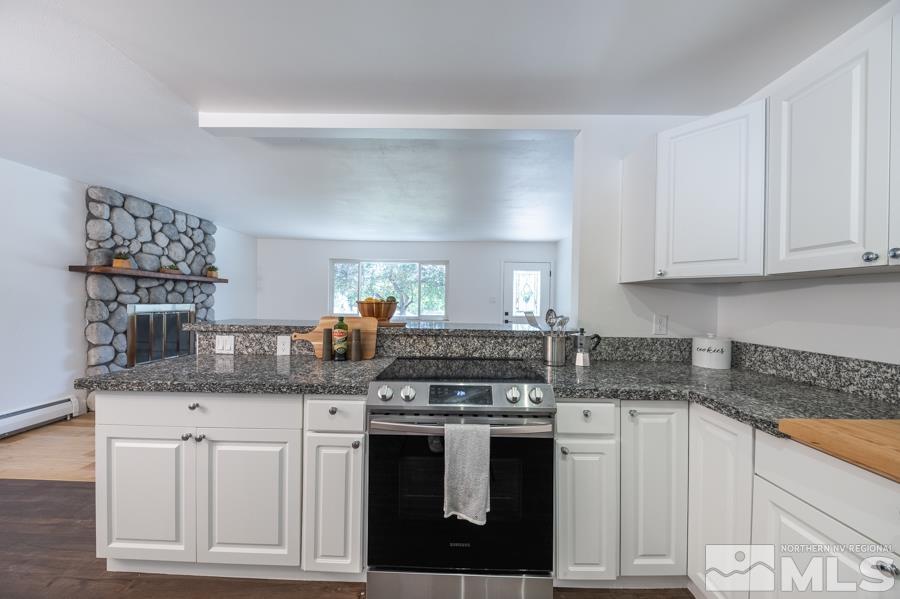 1325 Kings Court Reno, NV 89503 - Photo 5 of 14 a kitchen with granite countertop a stove sink and cabinets