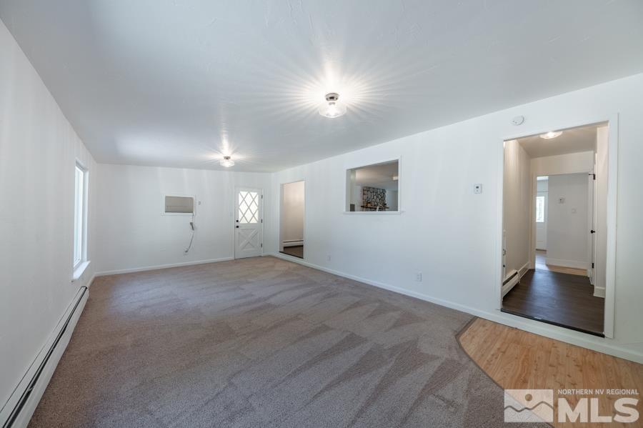 1325 Kings Court Reno, NV 89503 - Photo 7 of 14 an empty room with wooden floor and windows