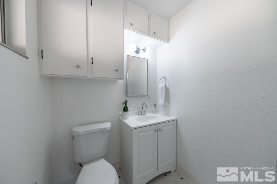 1325 Kings Court Reno, NV 89503 - Photo 8 of 14 a bathroom with a toilet sink and mirror