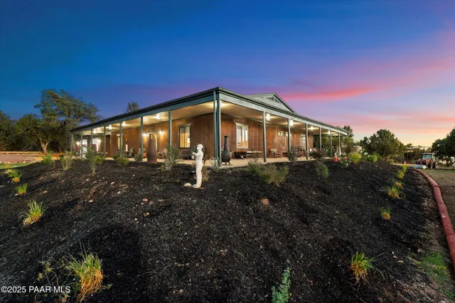 a dining room with furniture a chandelier and wooden floor