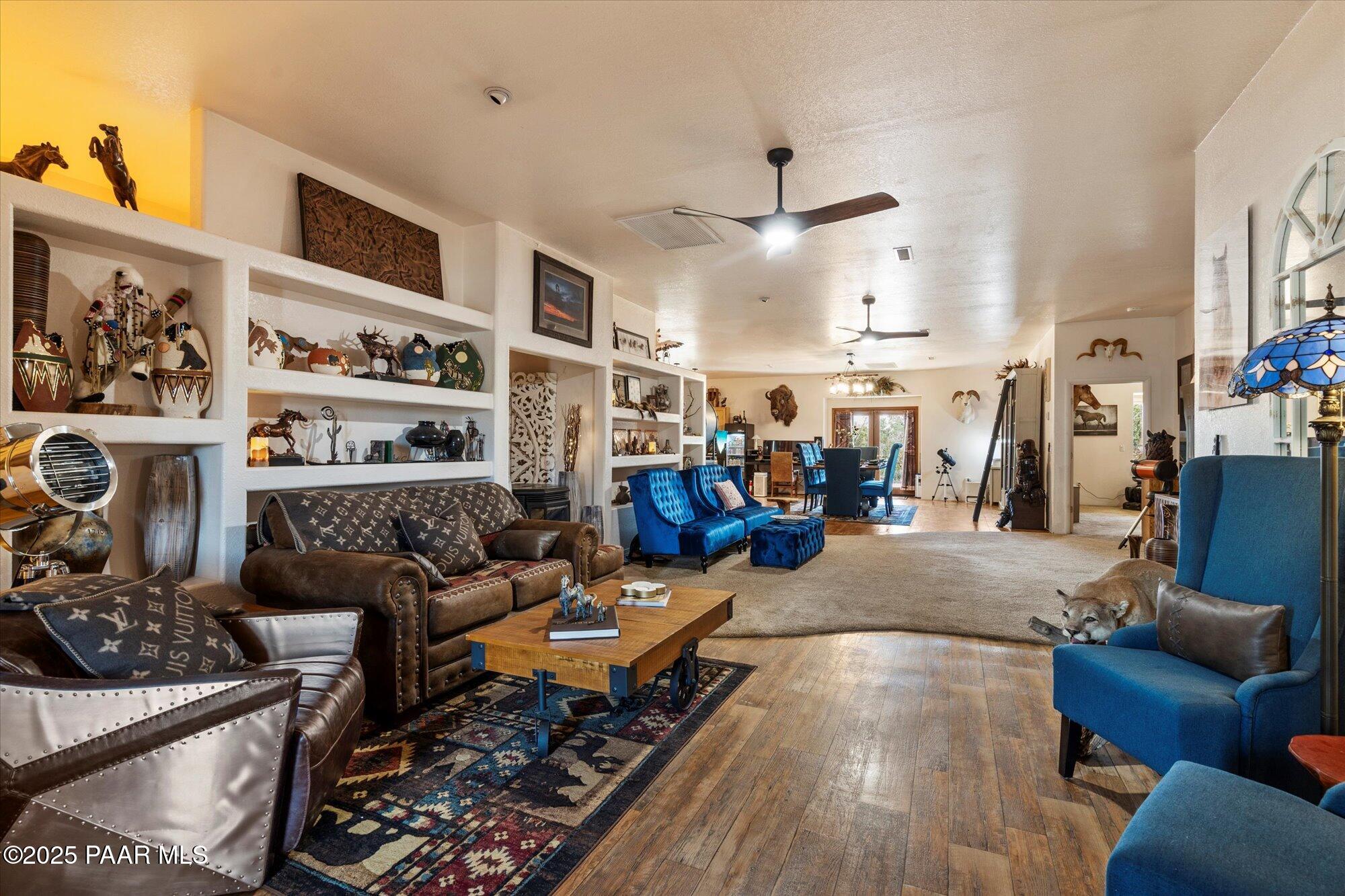 33425 Cowboy Clint Road Seligman, AZ 86337 - Photo 14 of 79 a living room with furniture kitchen view and a fireplace