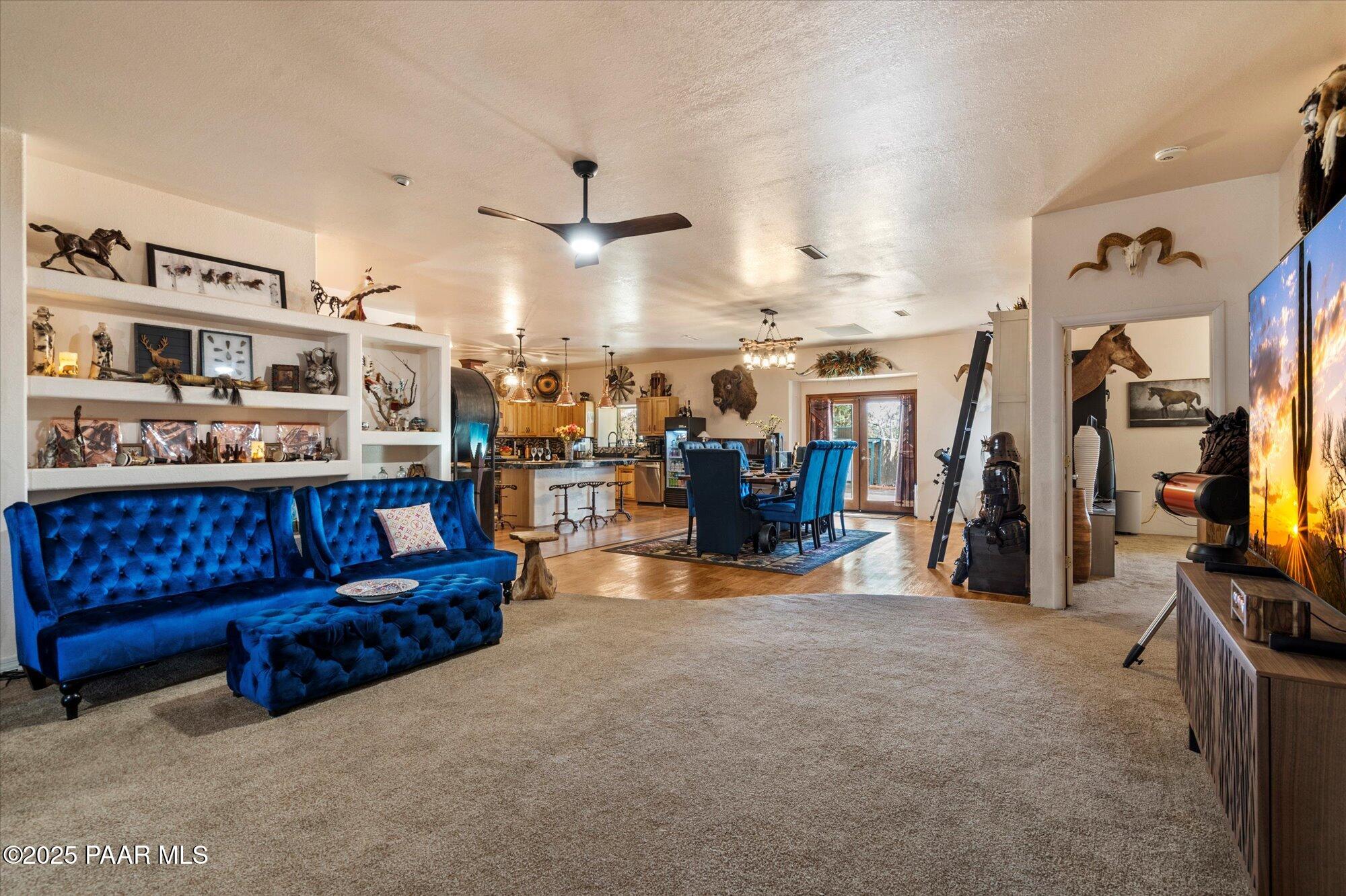 33425 Cowboy Clint Road Seligman, AZ 86337 - Photo 17 of 79 a living room with lots of furniture and a flat screen tv