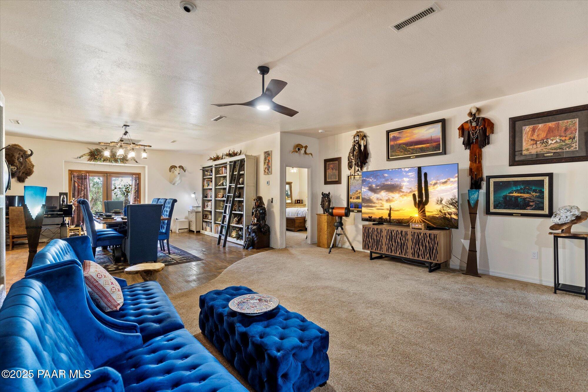 33425 Cowboy Clint Road Seligman, AZ 86337 - Photo 18 of 79 a living room with furniture and a flat screen tv