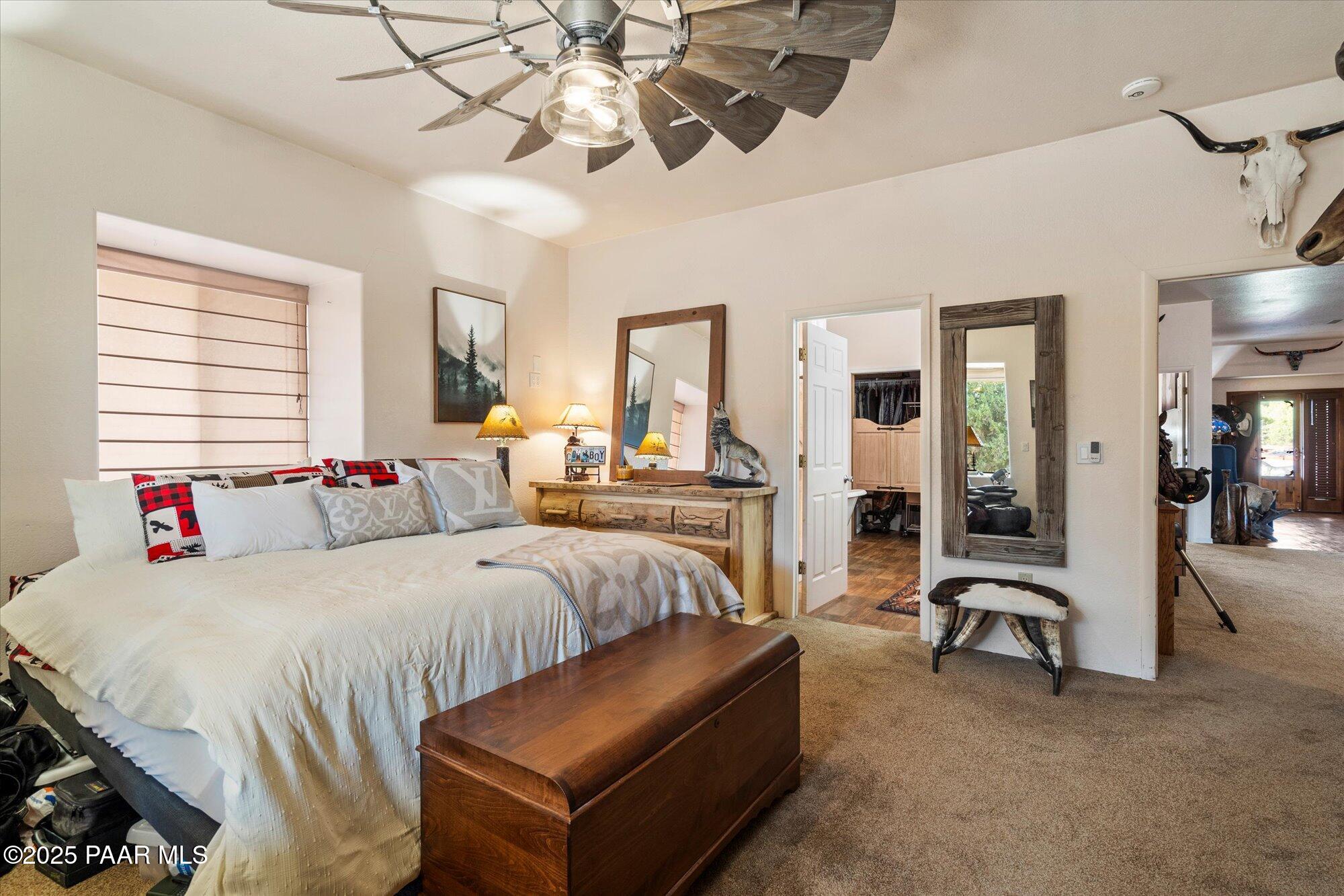 33425 Cowboy Clint Road Seligman, AZ 86337 - Photo 29 of 79 a bedroom with a bed couch and window