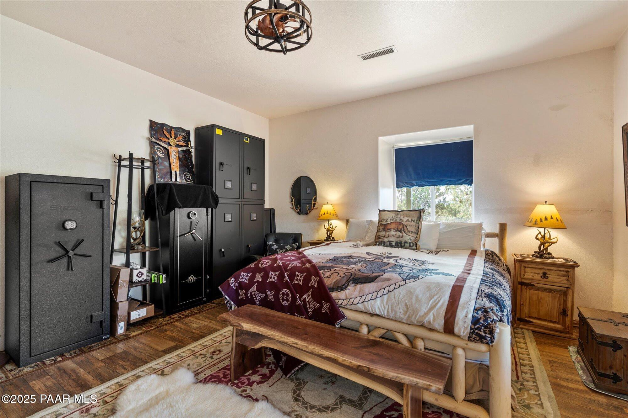 33425 Cowboy Clint Road Seligman, AZ 86337 - Photo 32 of 79 a bedroom with a bed and wooden floor