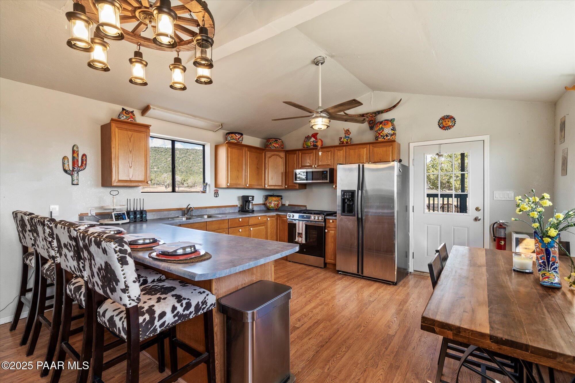 33425 Cowboy Clint Road Seligman, AZ 86337 - Photo 45 of 79 a view of a dining room with furniture a chandelier and wooden floor