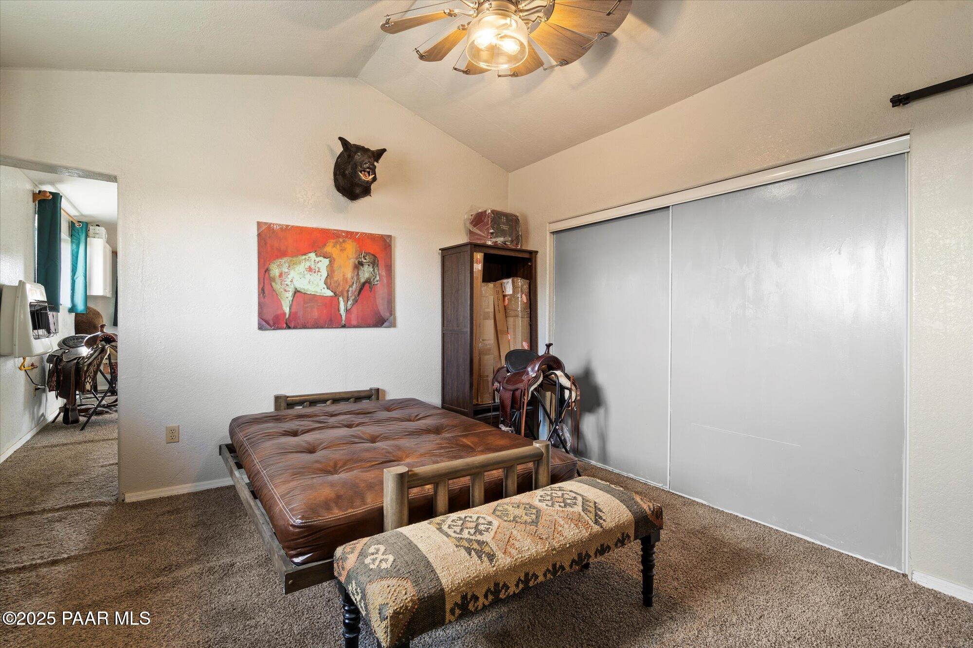 33425 Cowboy Clint Road Seligman, AZ 86337 - Photo 49 of 79 a bedroom with bed and a painting on the wall