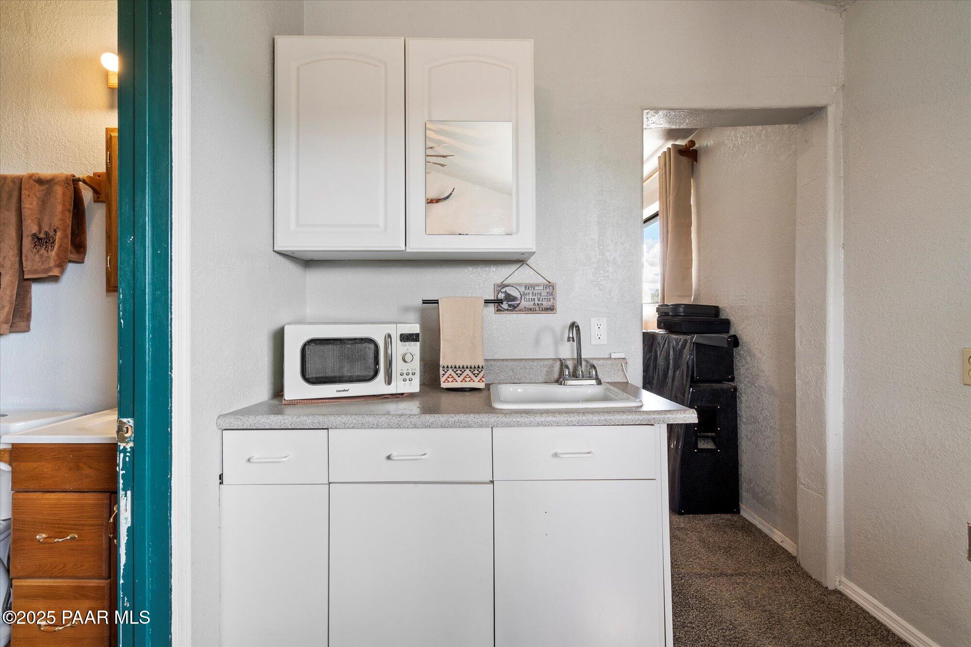 33425 Cowboy Clint Road Seligman, AZ 86337 - Photo 52 of 79 a bathroom with a sink and a mirror