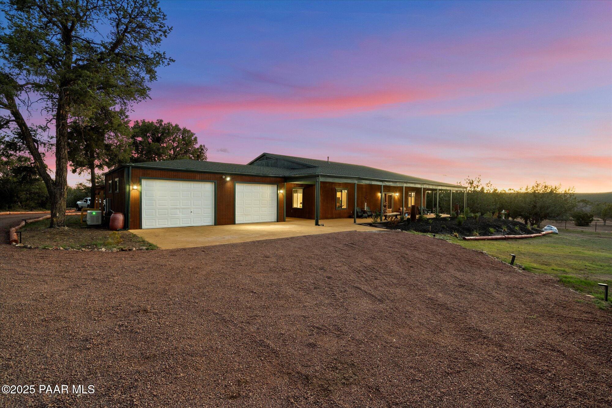 33425 Cowboy Clint Road Seligman, AZ 86337 - Photo 6 of 79 a front view of a house with a yard and garage