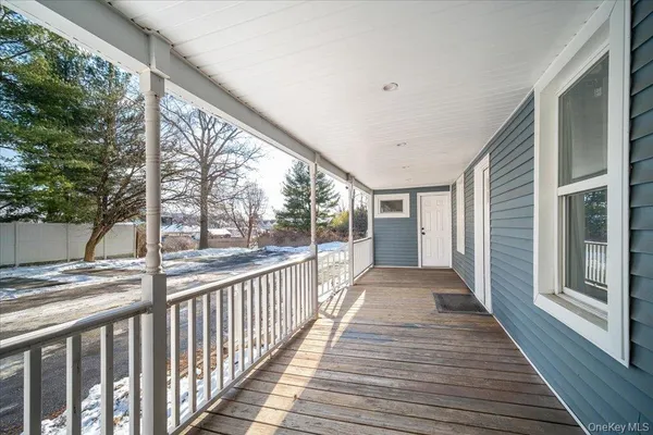 a view of a porch with wooden floor and stairs