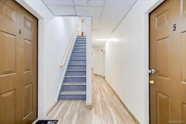 a view of a hallway with wooden floor and entryway