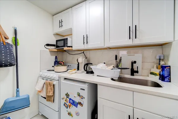 a kitchen with stainless steel appliances granite countertop a sink a stove and cabinets