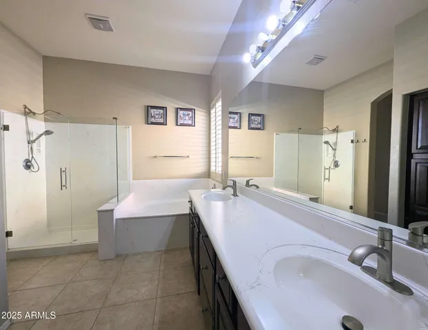 an empty room with a window and a ceiling fan